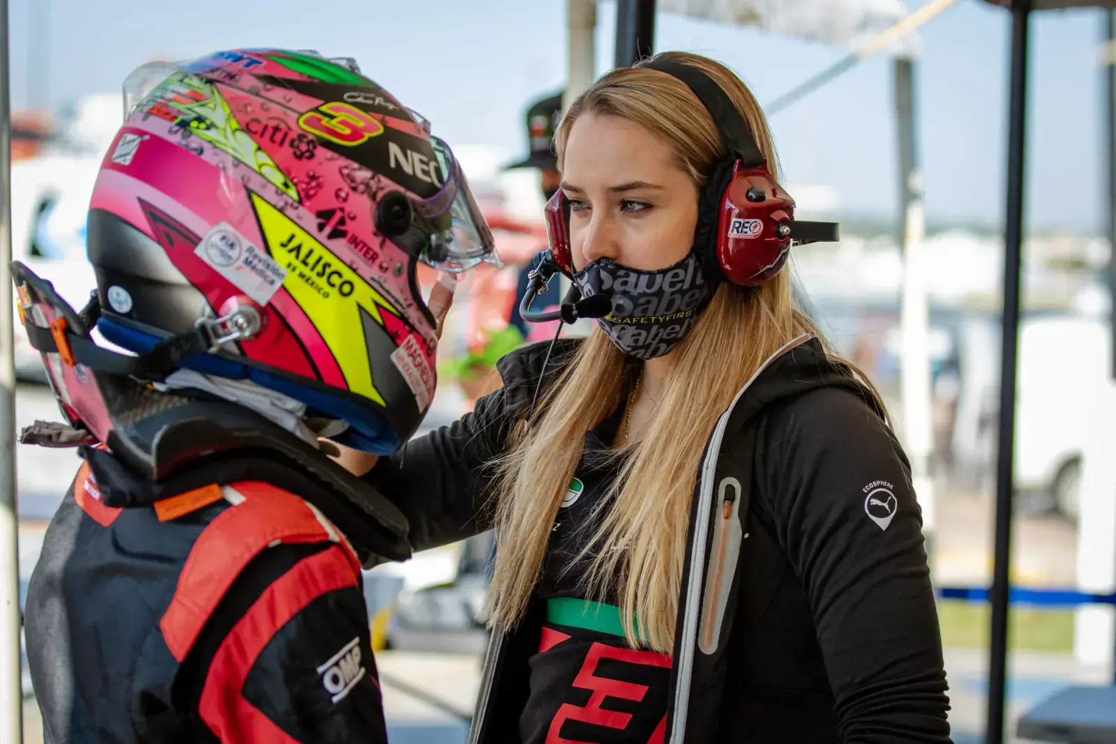 Sabré Cook coaching a fellow racing driver, providing instruction and mentorship