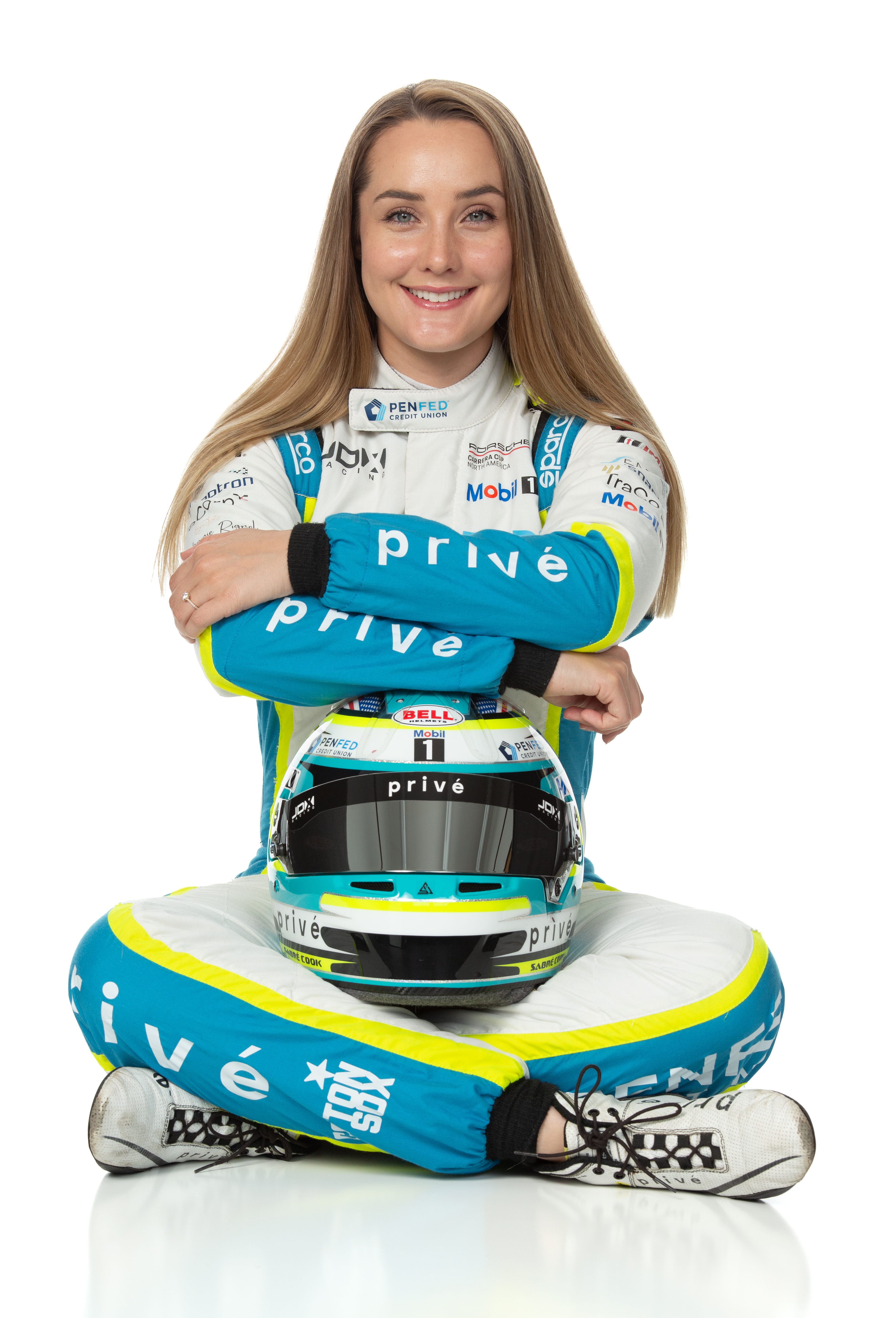 2025 Season Photo of Sabré sitting holding her helmet.